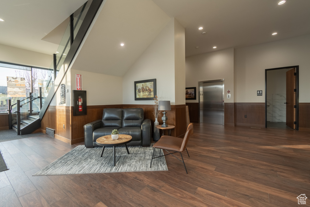 Living room featuring dark hardwood / wood-style floors and high vaulted ceiling