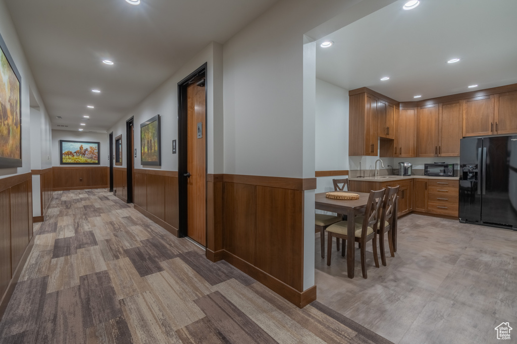 Hall with sink and light wood-type flooring