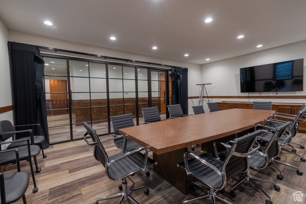 Office space with light hardwood / wood-style flooring