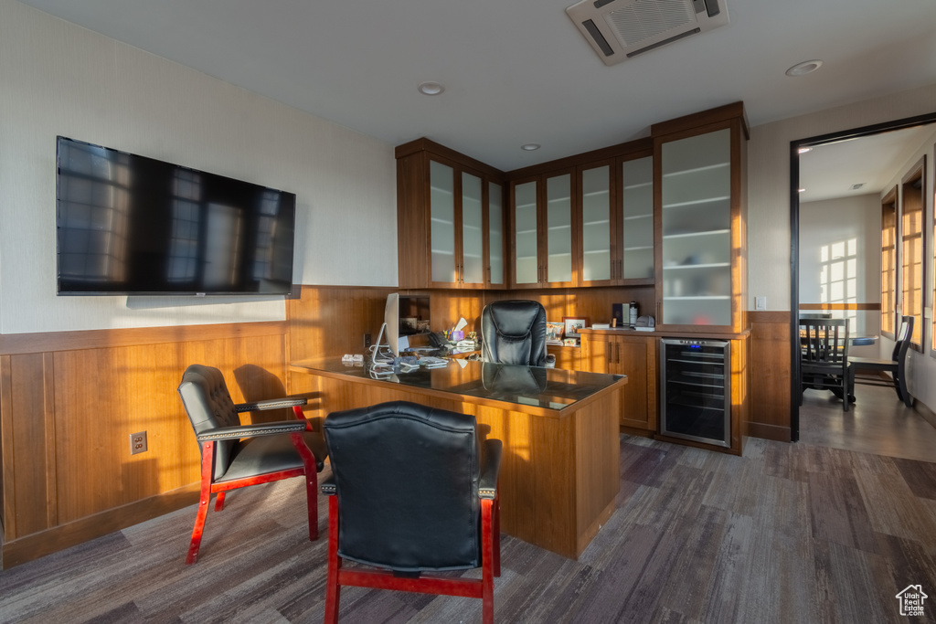 Home office featuring dark wood-type flooring and beverage cooler