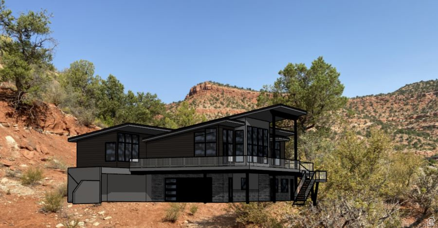 Back of property featuring a deck with mountain view