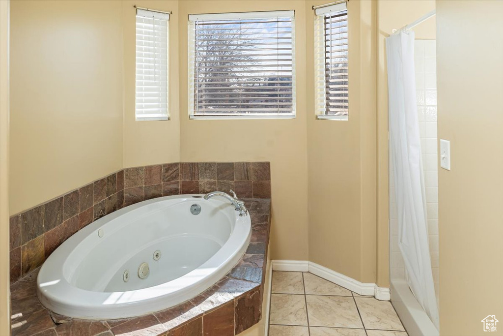 Bathroom featuring tile patterned flooring and shower with separate bathtub