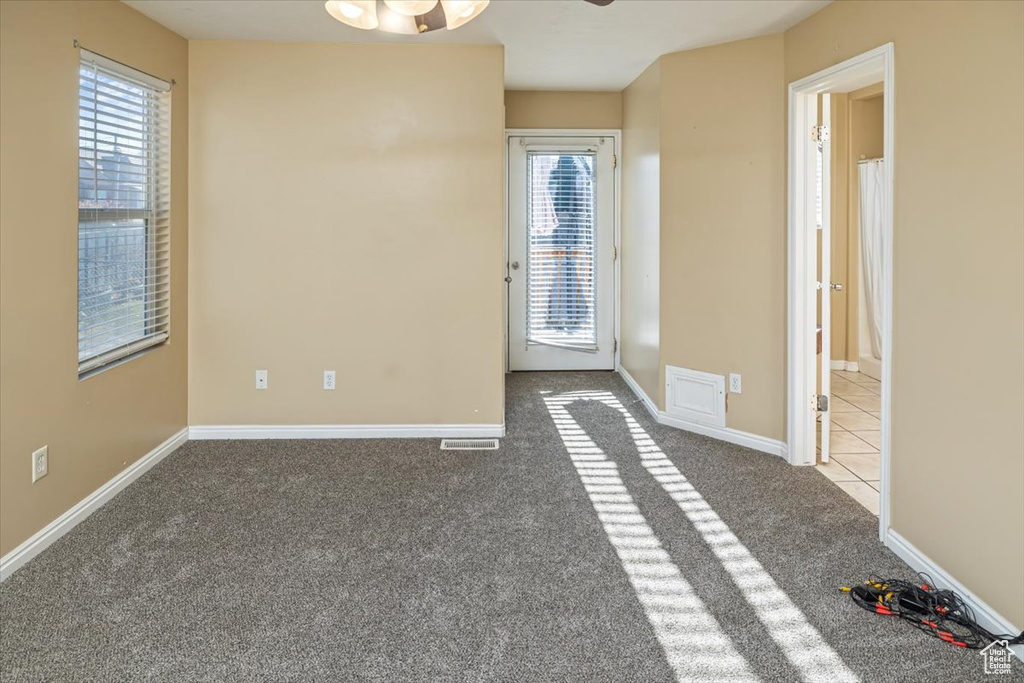 Unfurnished room featuring carpet flooring and ceiling fan