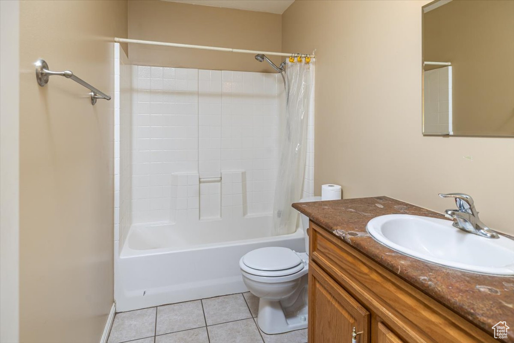 Full bathroom featuring tile patterned flooring, shower / bath combo, vanity, and toilet