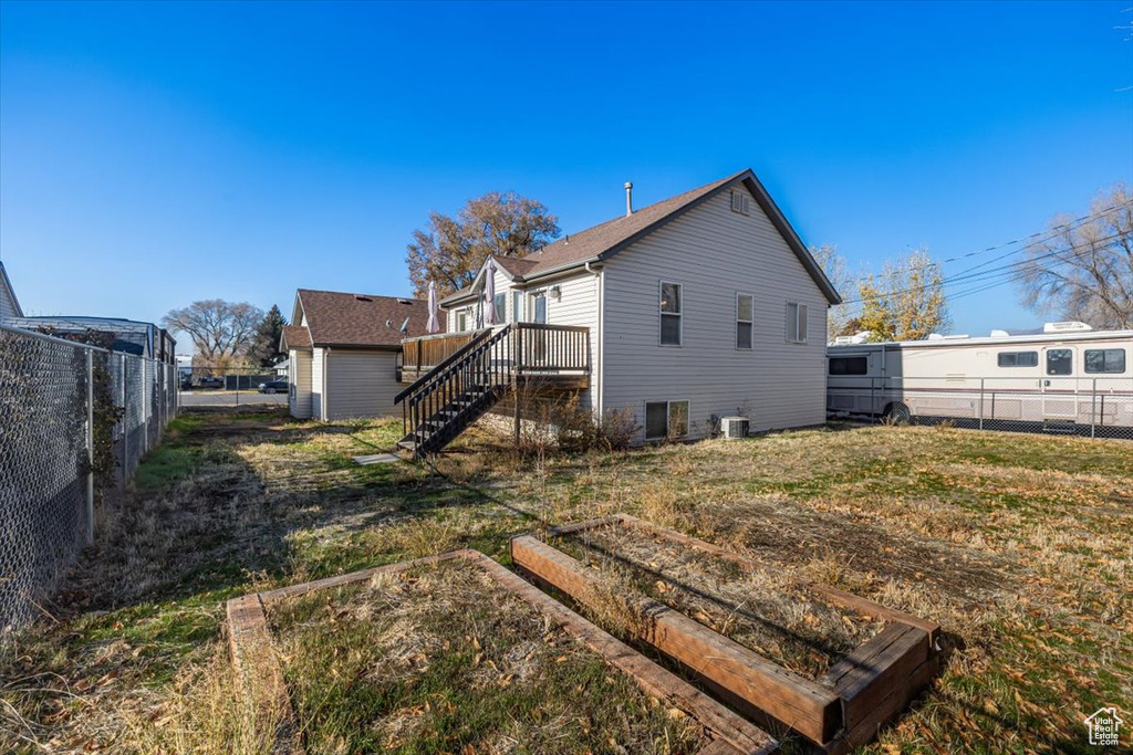 Rear view of property with central AC unit