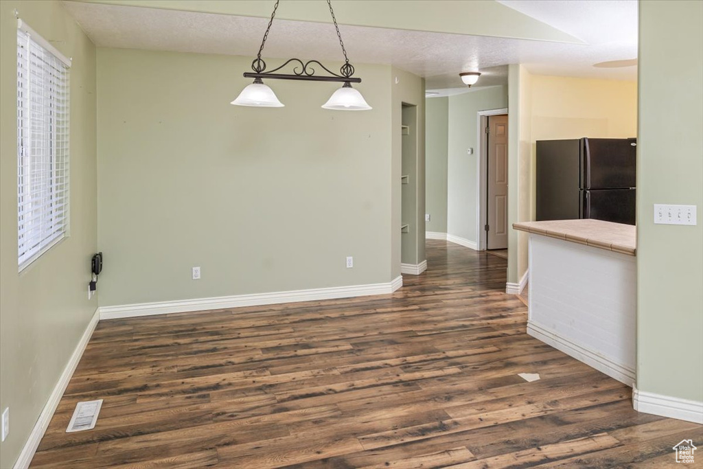 Interior space with dark hardwood / wood-style flooring