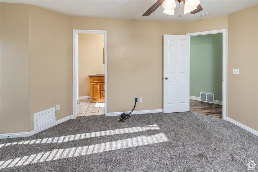 Unfurnished bedroom with carpet floors and ceiling fan