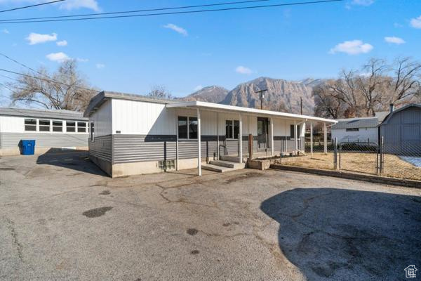 View of front of property featuring a mountain view and a porch