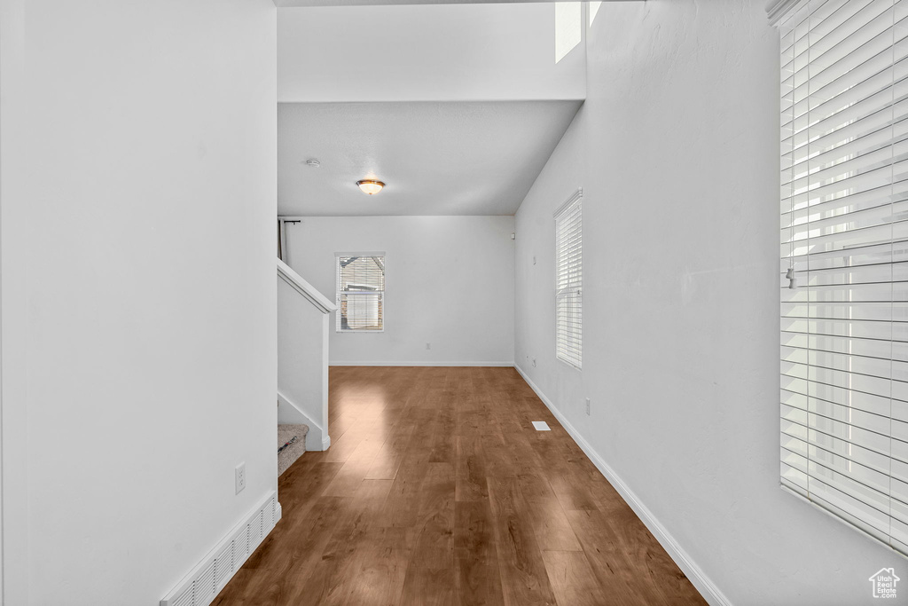 Unfurnished living room featuring dark hardwood / wood-style flooring