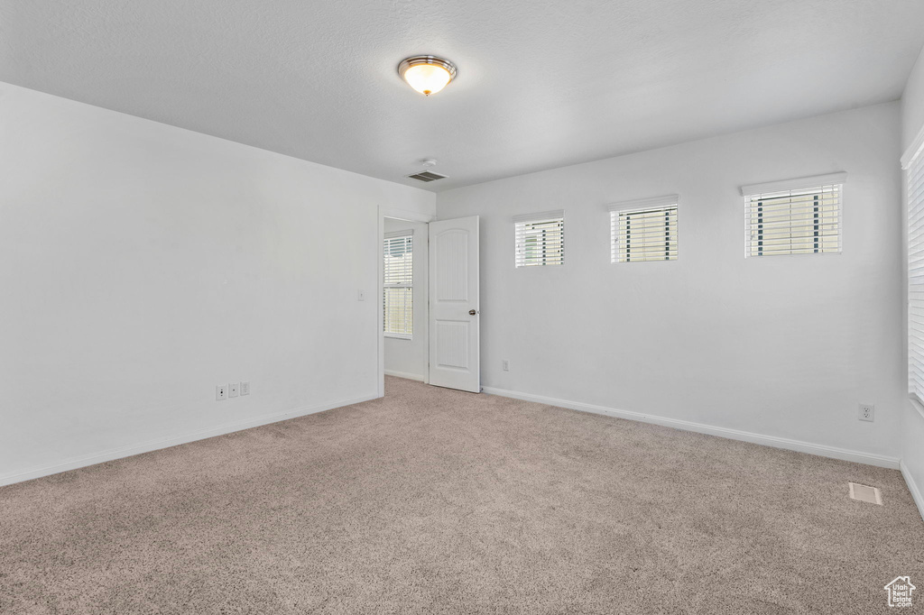 Spare room with plenty of natural light and carpet