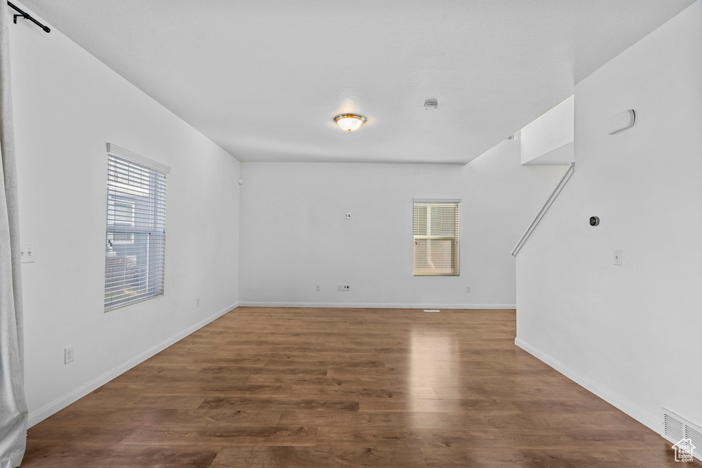 Unfurnished room featuring dark wood-type flooring