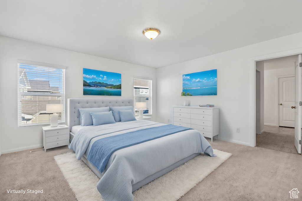 Bedroom featuring light carpet