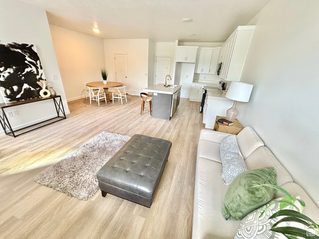 Living room with light wood finished floors and baseboards