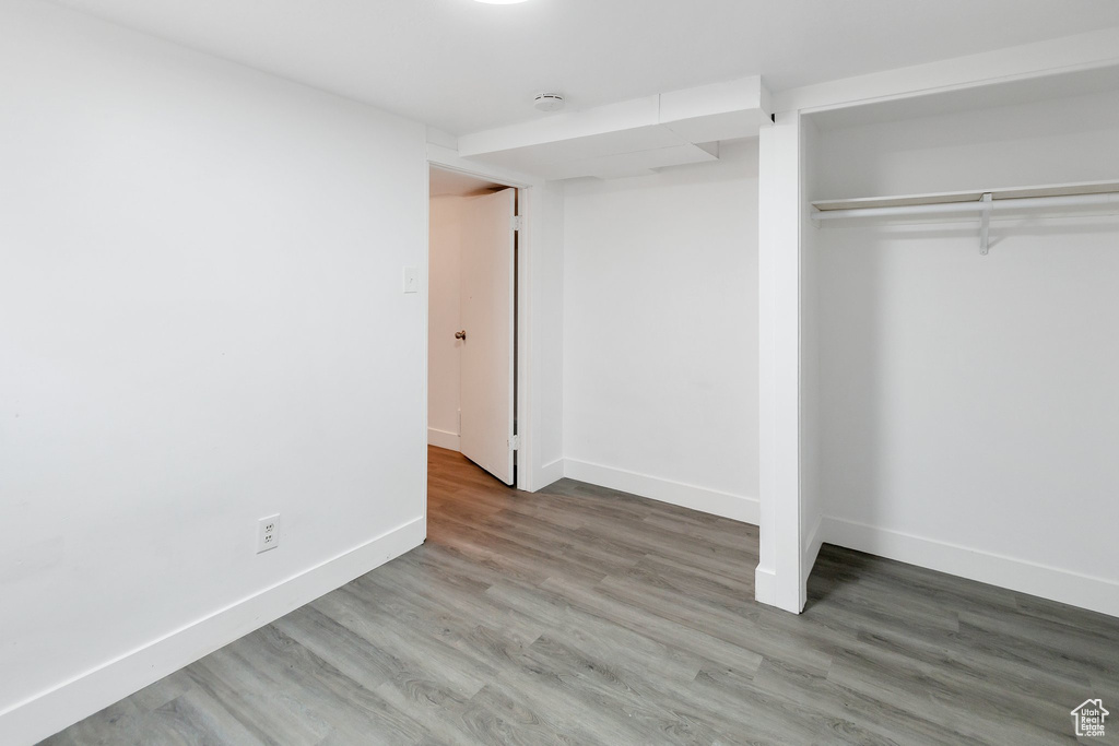 Unfurnished bedroom featuring wood-type flooring and a closet