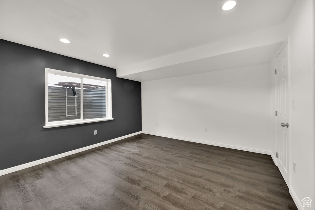 Empty room featuring dark wood-type flooring