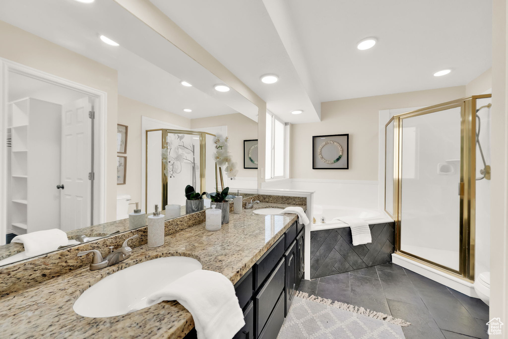 Bathroom with shower with separate bathtub, vanity, and tile patterned floors