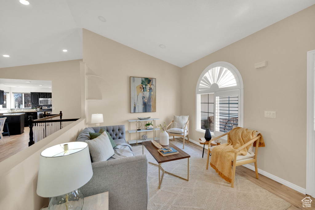 Living room featuring light hardwood / wood-style flooring and vaulted ceiling