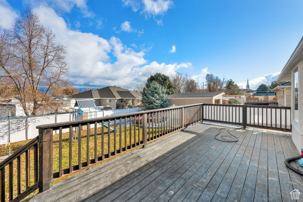 Wooden deck featuring a lawn