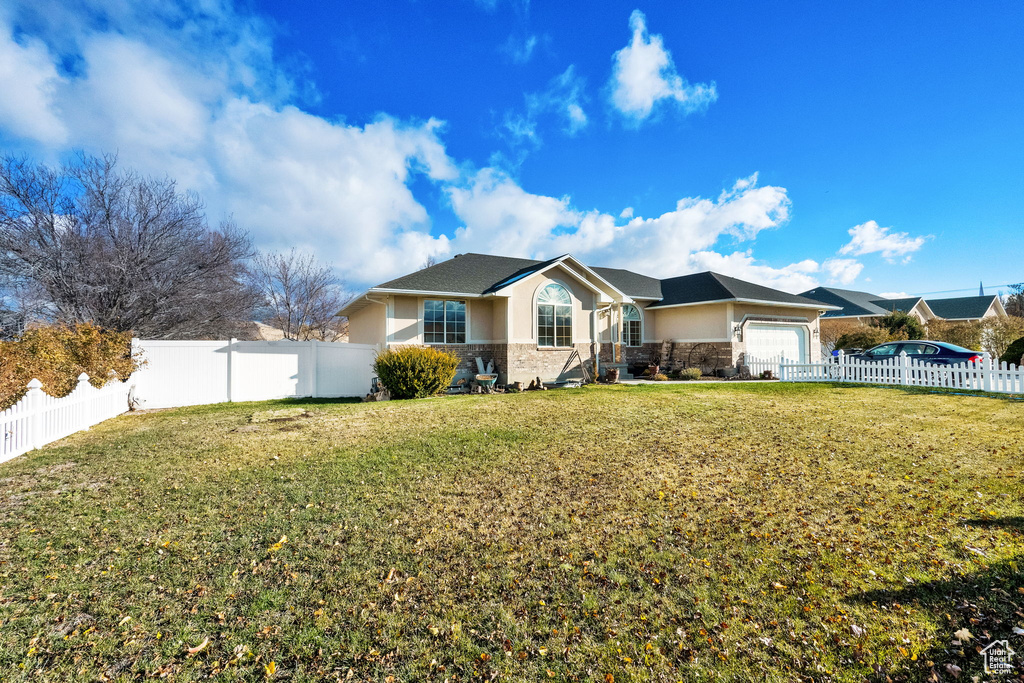 Single story home with a front lawn and a garage