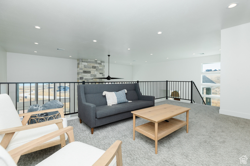 Living room featuring ceiling fan and light colored carpet