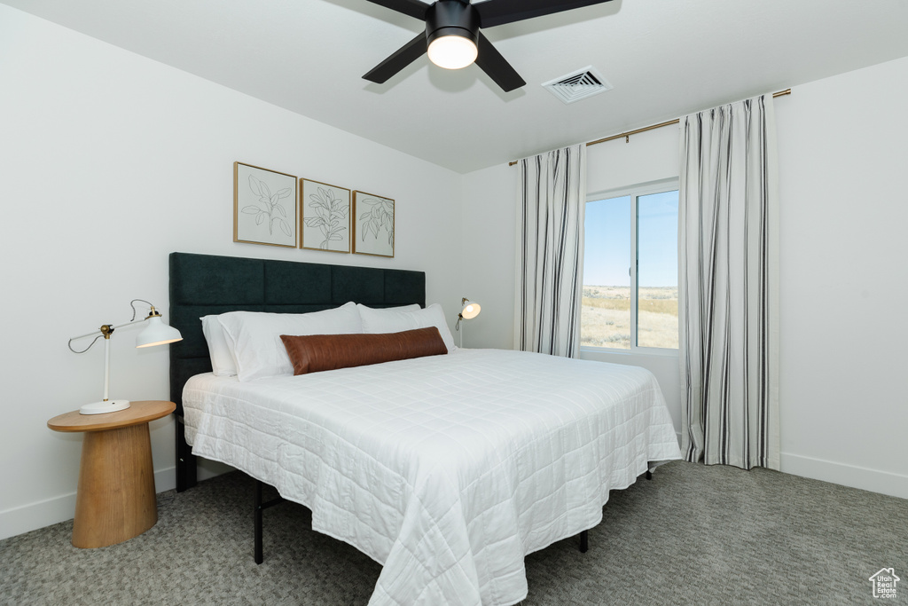 Bedroom featuring ceiling fan and carpet