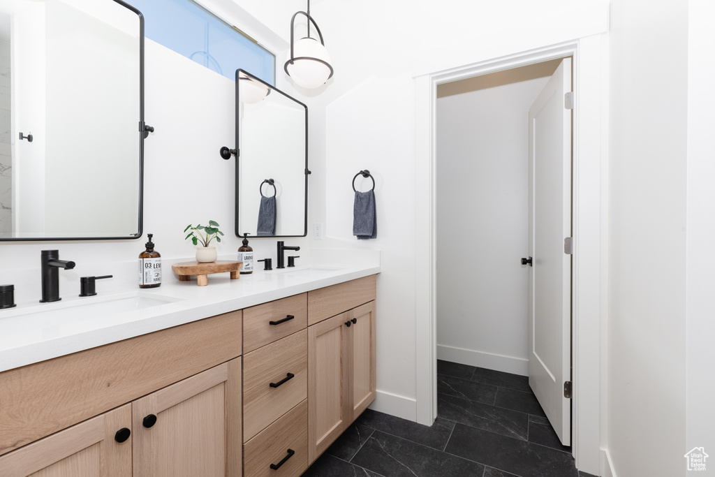 Bathroom with tile patterned floors and vanity