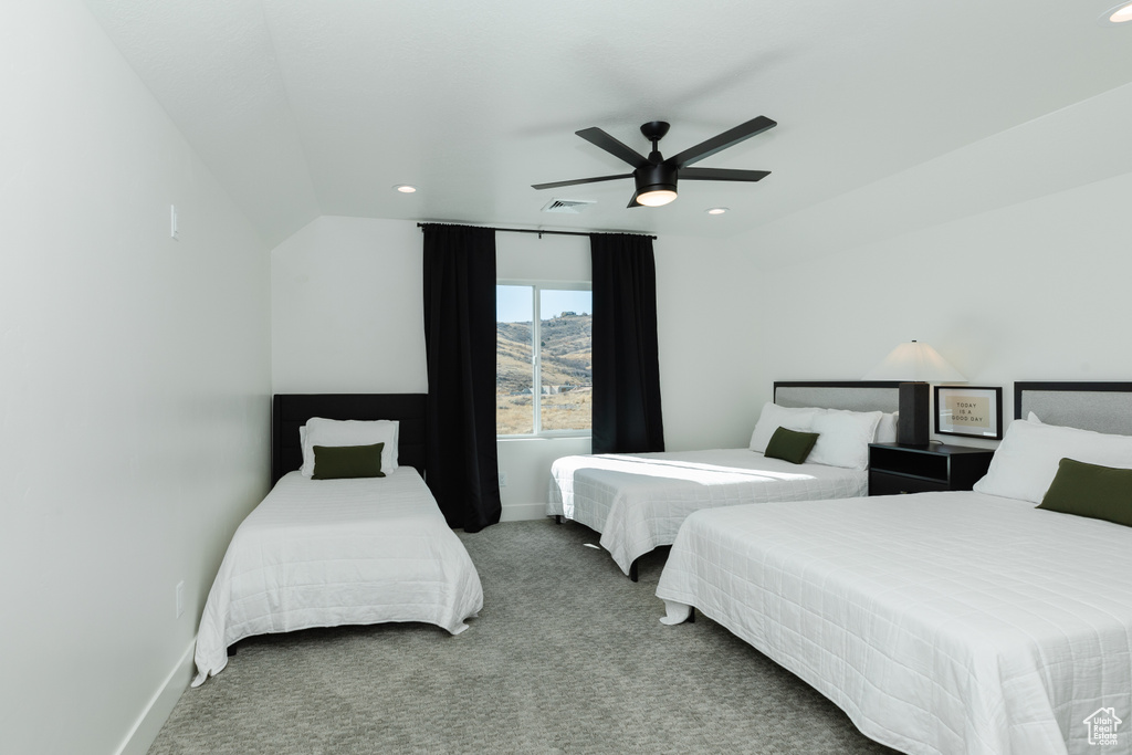 Bedroom with carpet, ceiling fan, and lofted ceiling