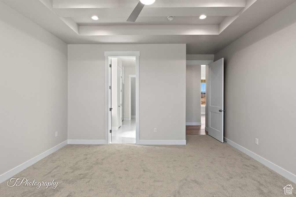 Unfurnished bedroom featuring a raised ceiling, carpet, baseboards, and recessed lighting