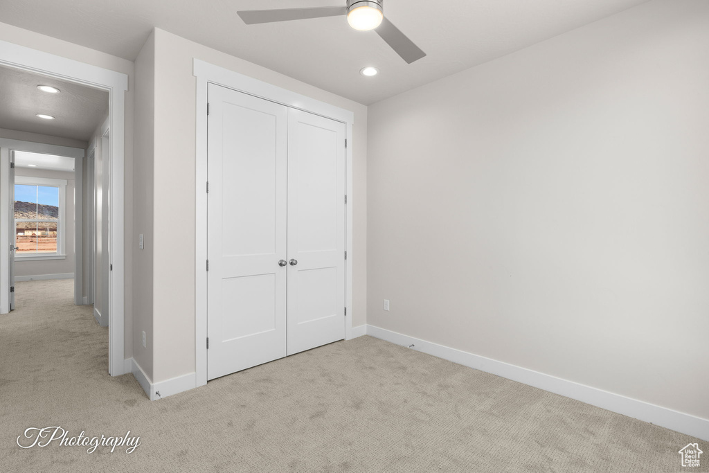 Unfurnished bedroom featuring carpet, a closet, baseboards, and recessed lighting