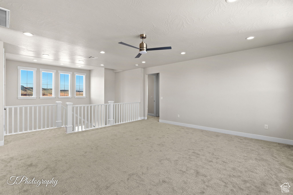 Spare room with recessed lighting, light colored carpet, ceiling fan, and baseboards