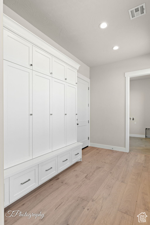 Mudroom with recessed lighting, light wood-style floors, and baseboards