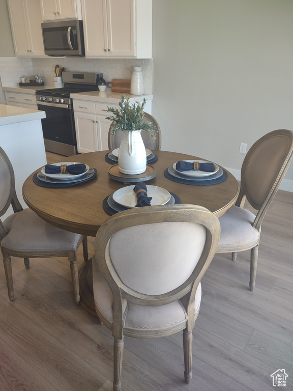 Dining space with light wood-style flooring