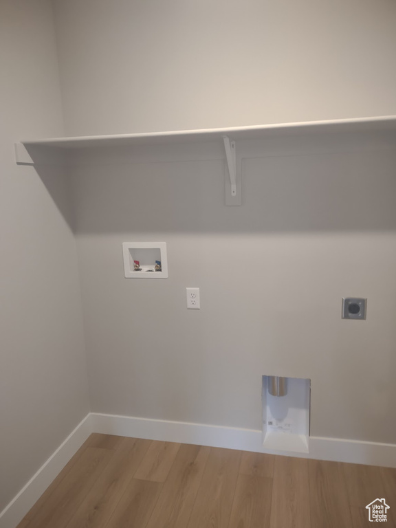 Laundry room with electric dryer hookup, washer hookup, and light wood-style flooring