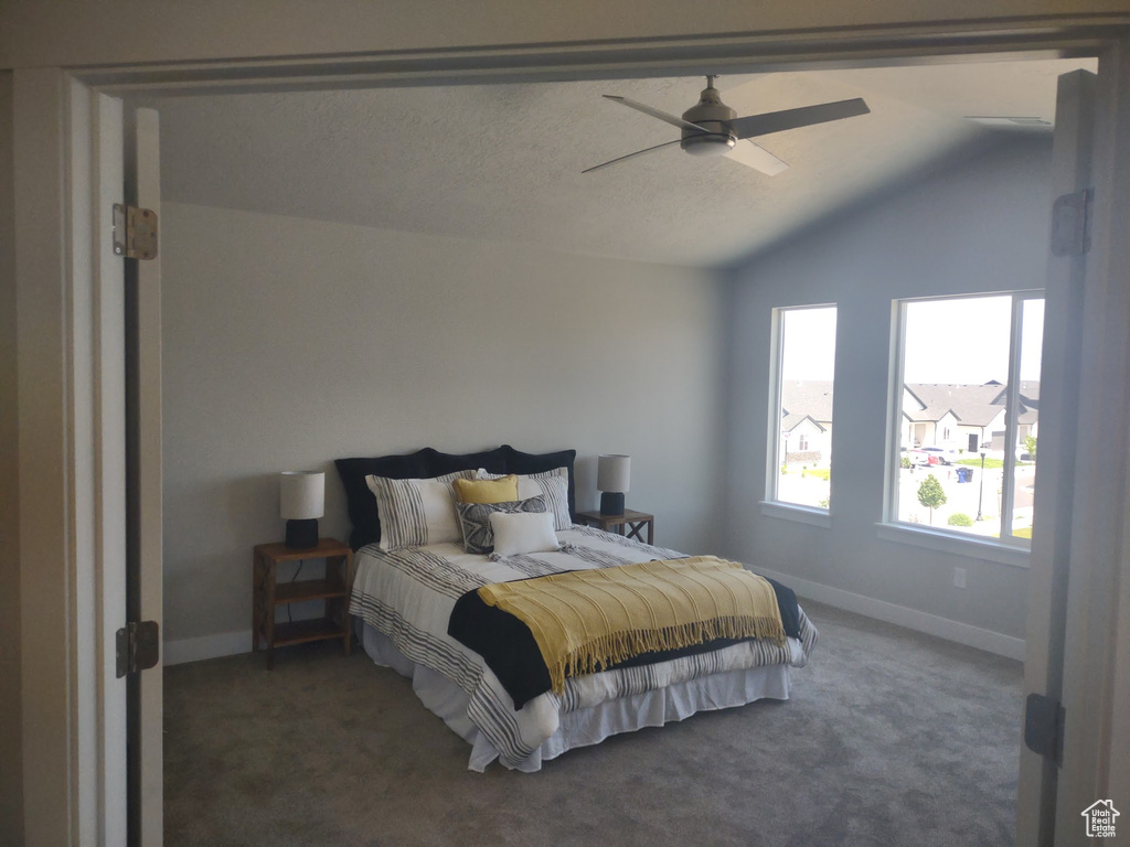 Bedroom with carpet, lofted ceiling, and ceiling fan