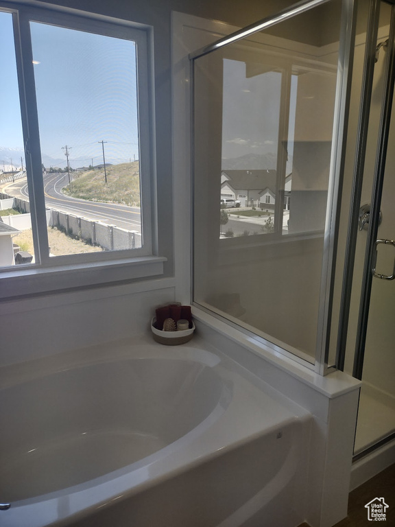 Full bathroom with a shower stall and a bath