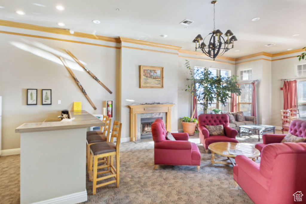 Living room featuring a fireplace, light colored carpet, a chandelier, and ornamental molding