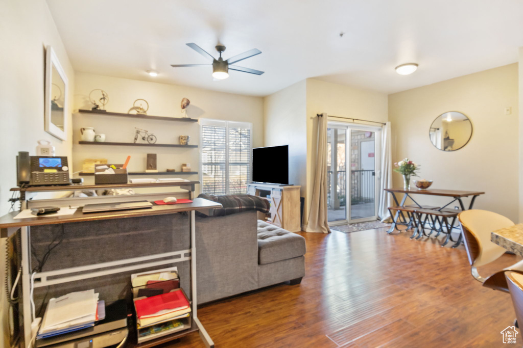 Living room with dark hardwood / wood-style floors and ceiling fan