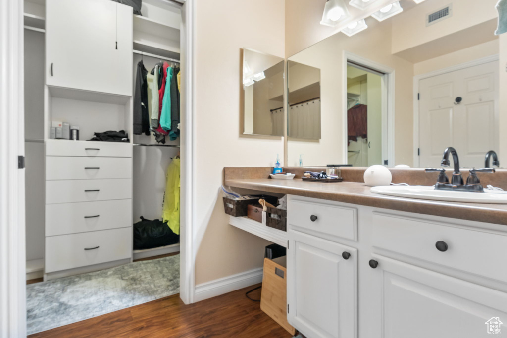 Bathroom featuring vanity and hardwood / wood-style flooring