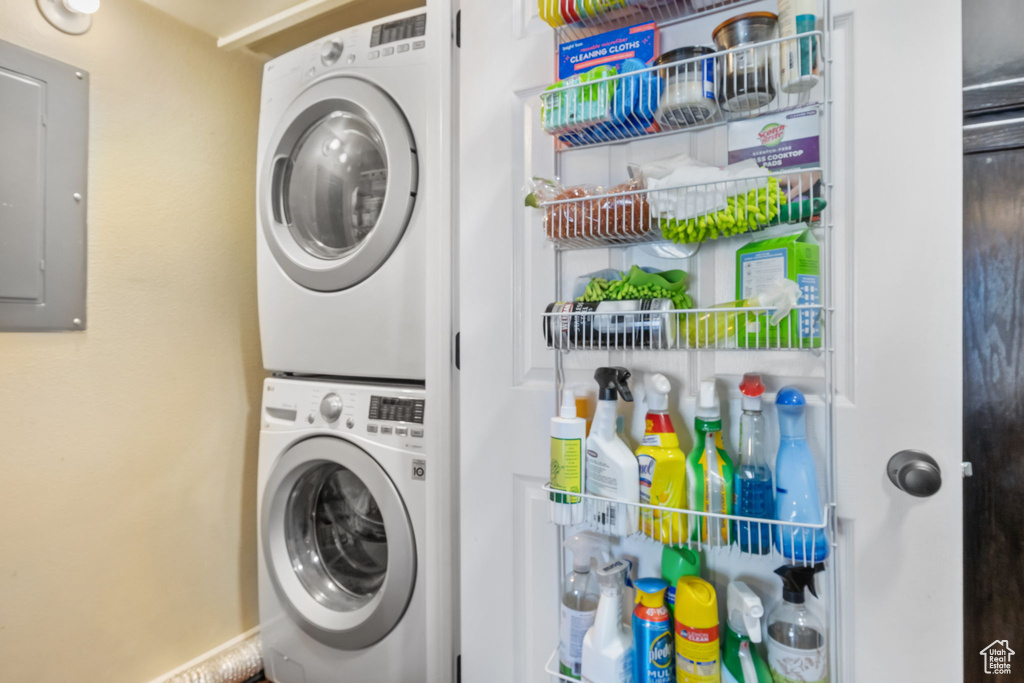 Washroom with electric panel and stacked washing maching and dryer