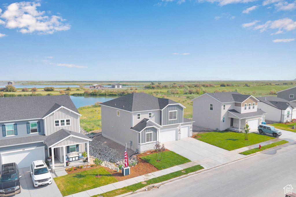Aerial view of residential area featuring a large body of water