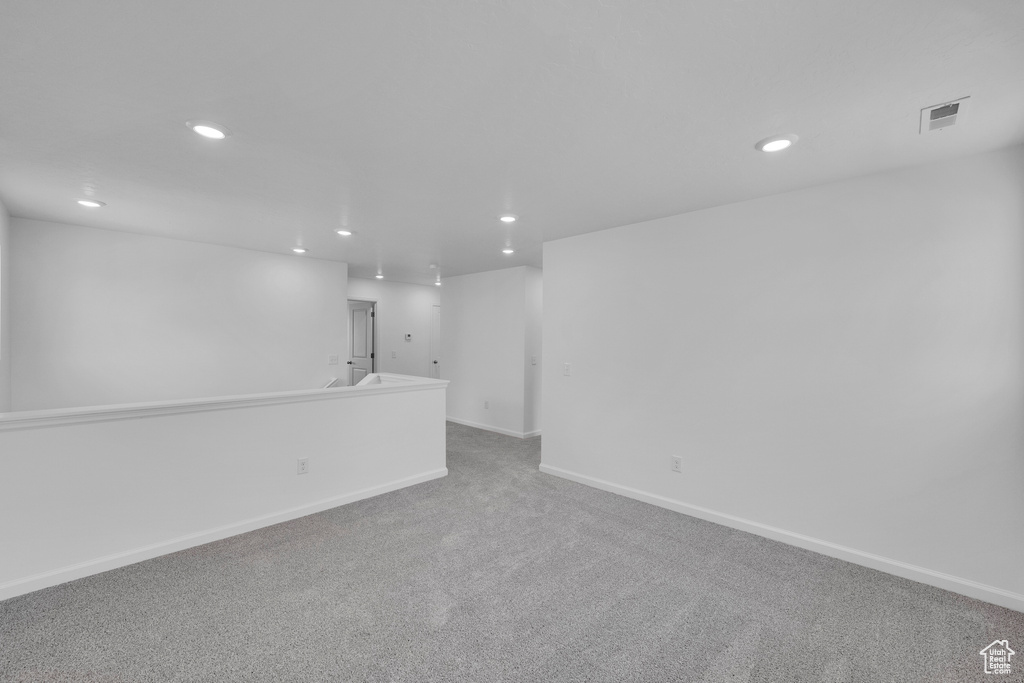 Spare room featuring recessed lighting, carpet flooring, and baseboards