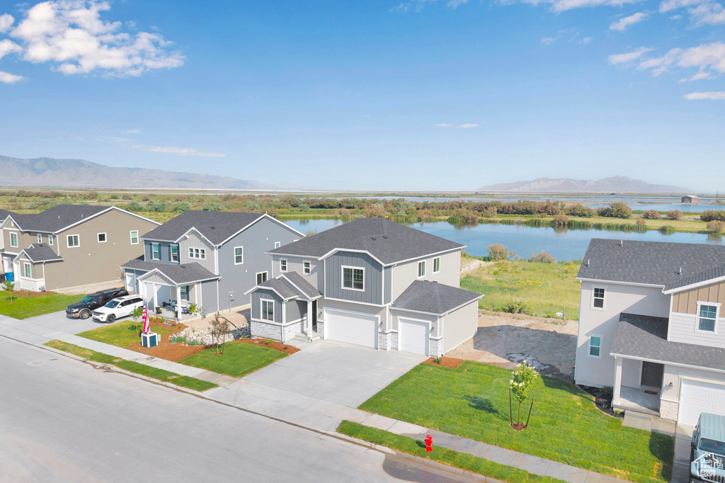 Aerial perspective of suburban area with a water and mountain view