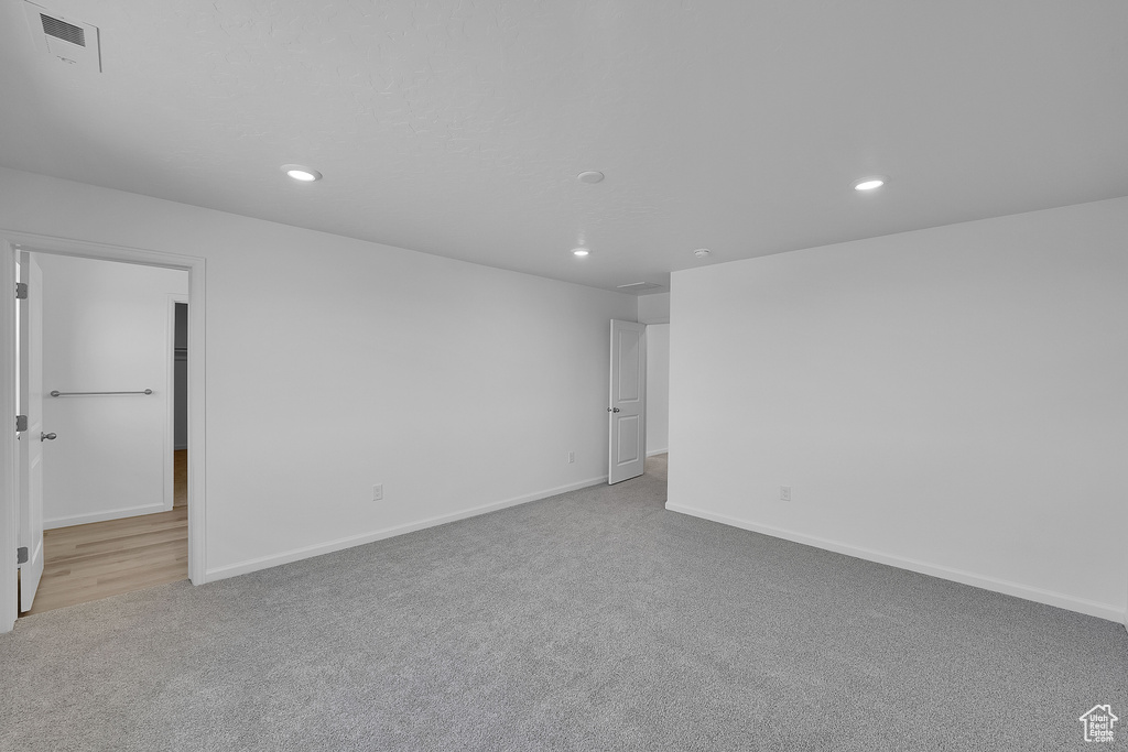 Empty room with carpet, recessed lighting, and baseboards