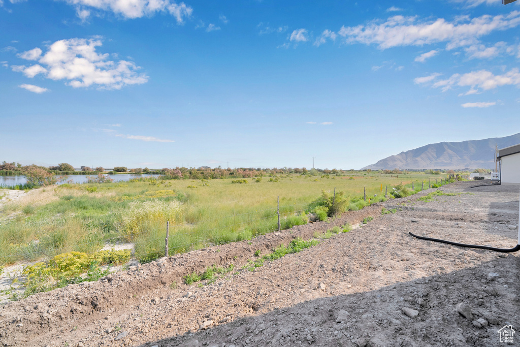 View of yard with a water and mountain view