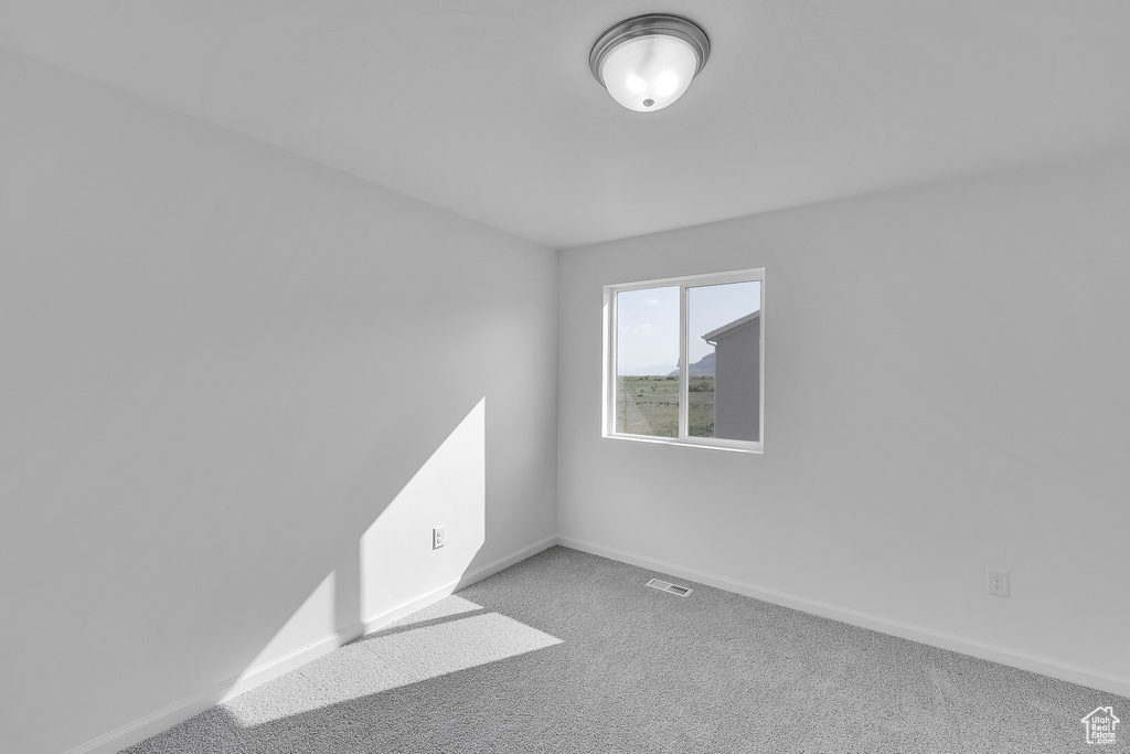 Empty room with baseboards and carpet floors