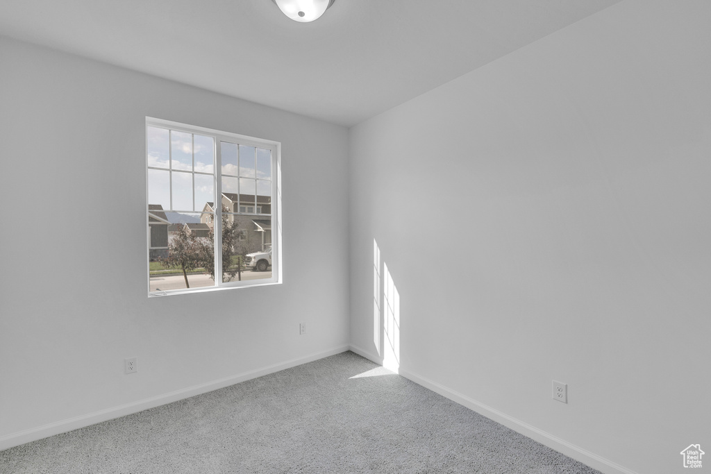 Empty room with baseboards and carpet floors