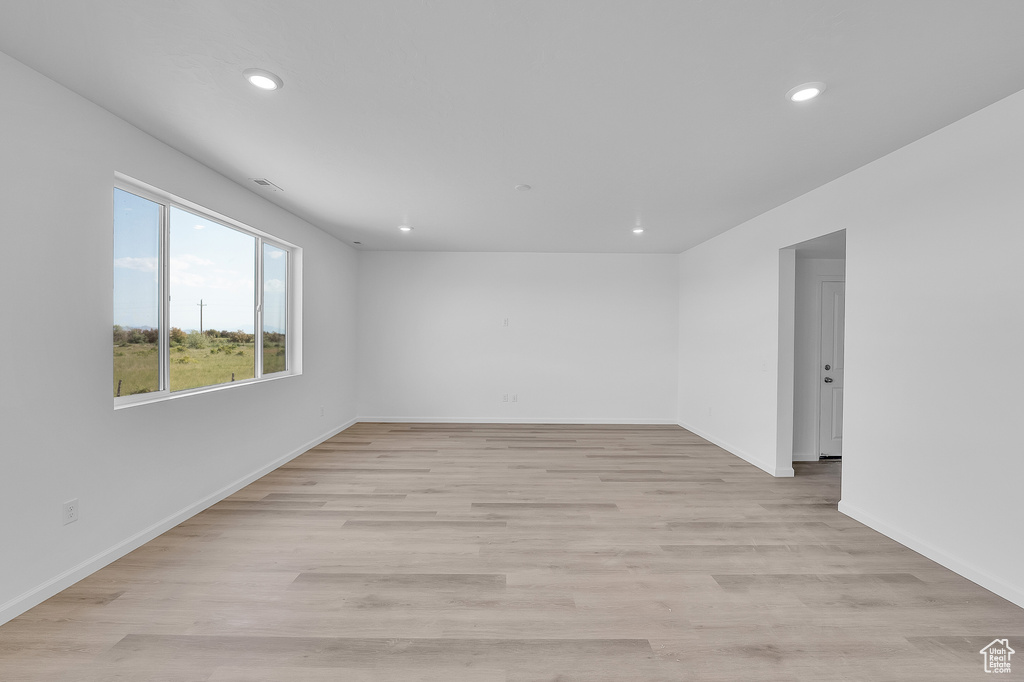 Spare room with recessed lighting, light wood-style flooring, and baseboards