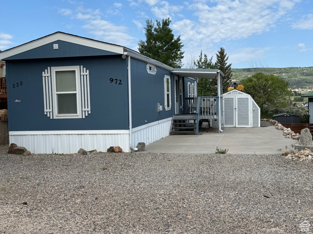 View of side of home featuring a patio