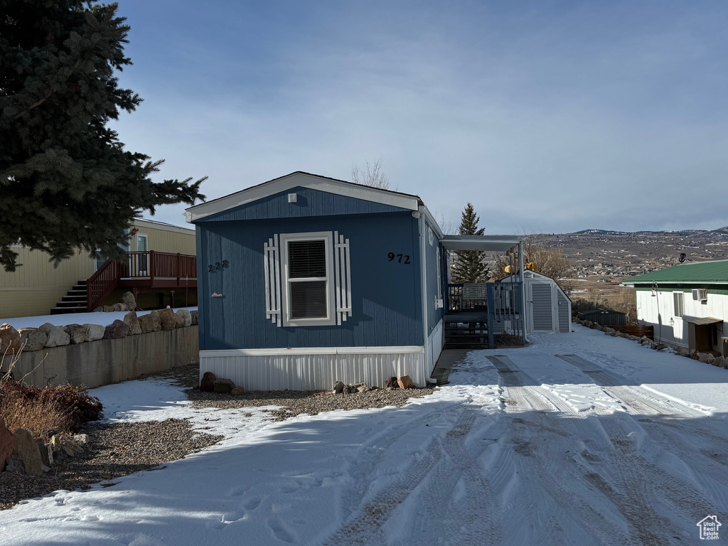 View of front of house with a storage unit