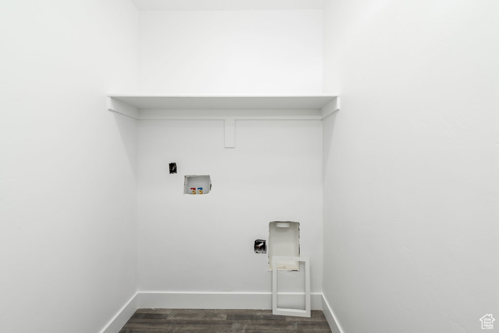 Clothes washing area featuring dark hardwood / wood-style flooring, hookup for a washing machine, and hookup for an electric dryer